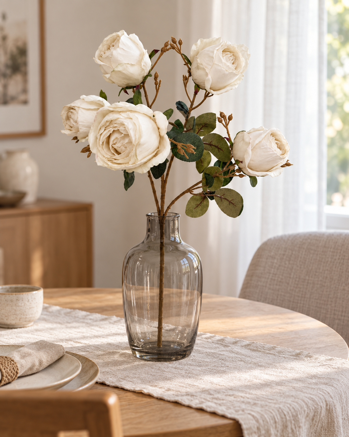 One EVERLA white artificial rose spray with exactly five heads in a smoky glass vase on a light oak dining table; vase not included.