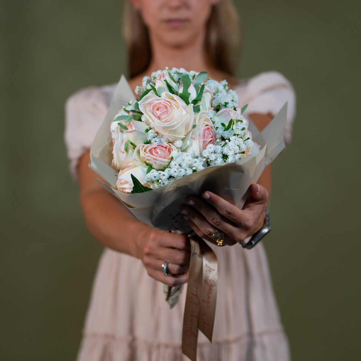 Blush and ivory rose bouquet held in the hands