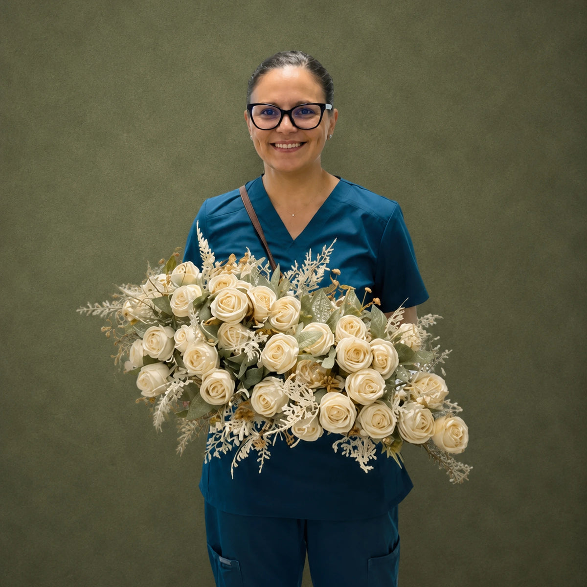 cream roses artificial floral arrangement premium tabletop centerpiece decor lifestyle scene: host or florist placing arrangement