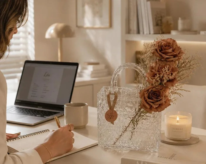 Glass flower bag with roses on a desk