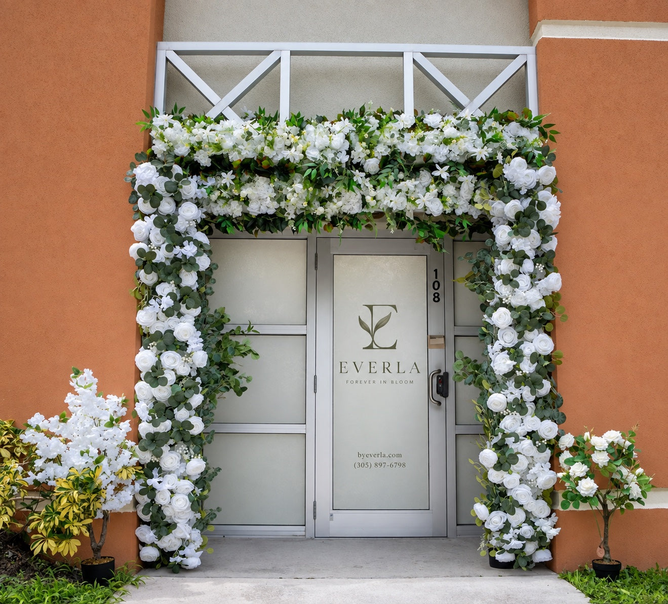 EVERLA’s Doral entrance with white flowers framing the door